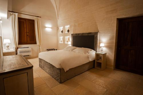 Ένα ή περισσότερα κρεβάτια σε δωμάτιο στο Masseria Torleanzi Wine Relais