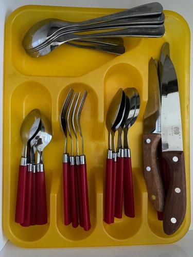 a yellow plastic tray with utensils in it at Spiranca Luxury Apartments in Tirana