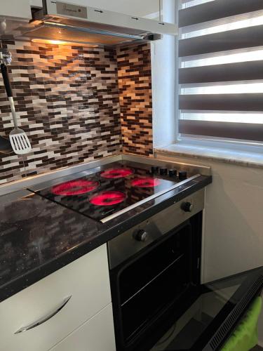 a kitchen with a stove and a counter top at Spiranca Luxury Apartments in Tirana