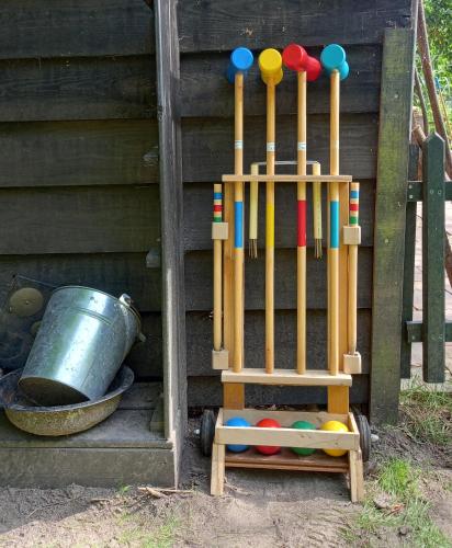 a group of baseball bats and balls on a wooden structure at B&B Wood, Food & More in Alphen