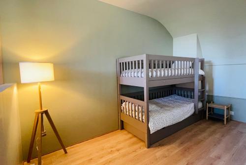 a baby room with a bunk bed with a lamp at La Bastide Champenoise - Chambres d'hôtes in Villers-Allerand