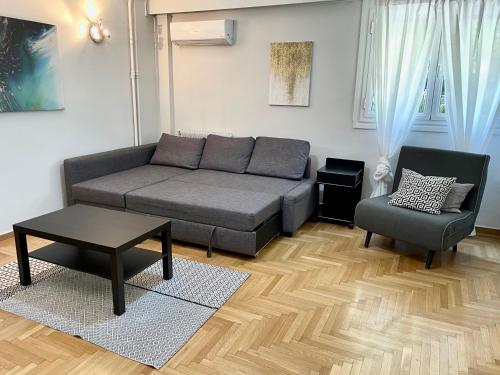 a living room with a couch and a chair at Lycabettus Luxury Cave greendom in Athens