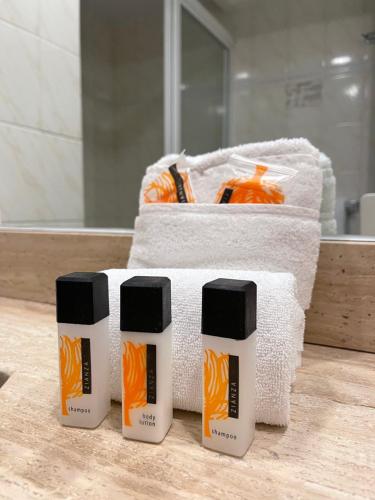 three bottles of bleach sitting on top of towels at Hotel Catedral in Mexico City
