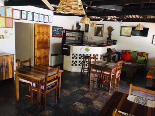 a kitchen and dining room with a table and chairs at Green Tree Lodge in Livingstone