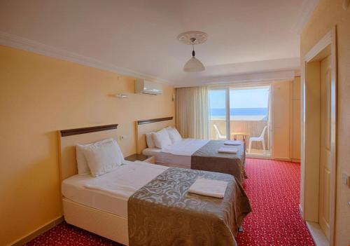 A bed or beds in a room at AZAK BLUE OTEL