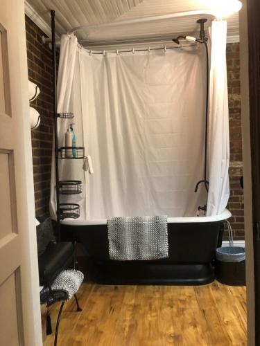 a black bath tub in a room with a shower at Belmont Inn in Shelbyville
