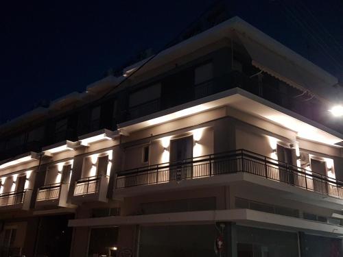 a white building with lights on it at night at K35 Apartments in Preveza