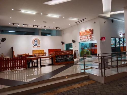 a restaurant with a table in the middle of a building at Comfortable18 3R2B 7pax Meritus Perai in Perai