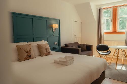 A bed or beds in a room at Ballinluig Rooms & Suites