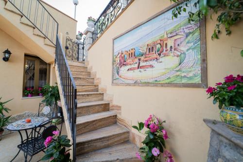 a set of stairs with a mural on the side of a building at Tyche apartaments & rooms in Taormina