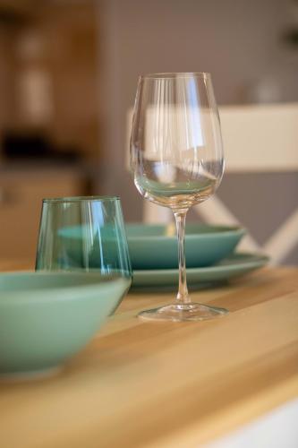 two wine glasses sitting on top of a table at Gold Sun Villas in Nafplio