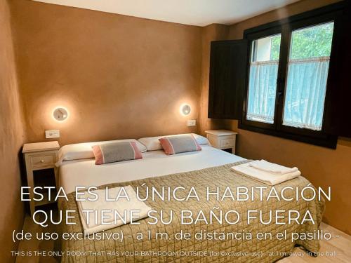 a bedroom with a bed and a window at CASA DEL AGUA - La Rioja in Santa Coloma