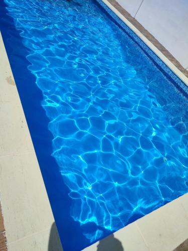 a swimming pool with blue water at Vila Perla Govorei in Băile Govora