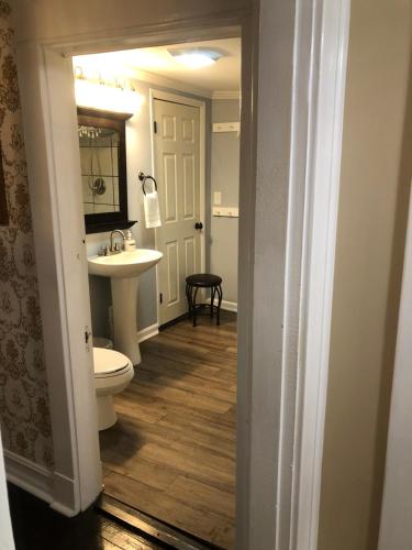 a bathroom with a toilet and a sink at Belmont Inn in Shelbyville