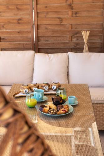 a table with a plate of food on a couch at Gold Sun Villas in Nafplio