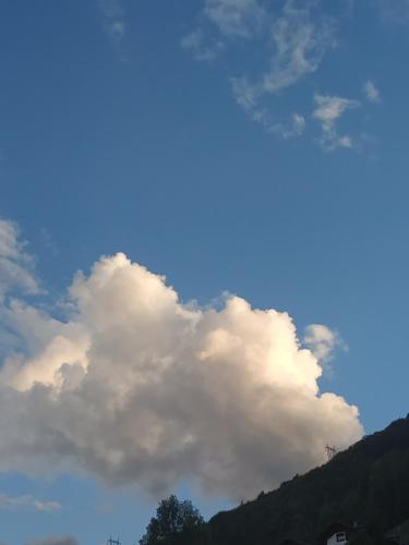 a large cloud in the sky above a mountain at Villa Geltrude in Cusio