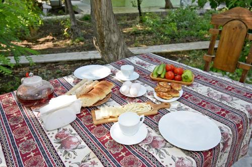 a picnic table with plates and food on it at Forest Hills in Yerevan