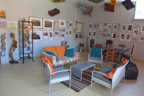 a room with chairs and a table and pictures on the wall at Casa Mariolas in Manteigas