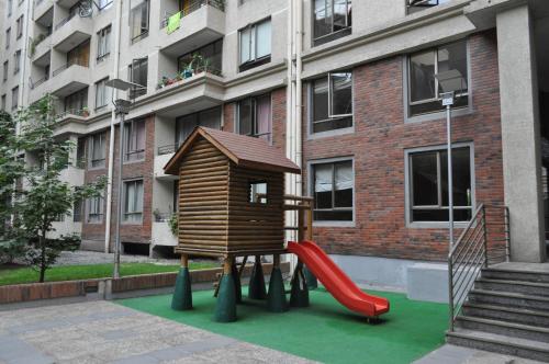 a playground with a slide and a play structure at Barrio Lastarria, Excelentes Apartamentos - Sofia Camilla Propiedades in Santiago