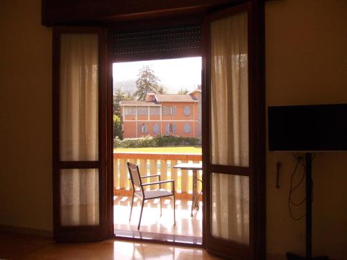 een glazen schuifdeur naar een patio met een stoel bij Villa Costanza in Bobbio
