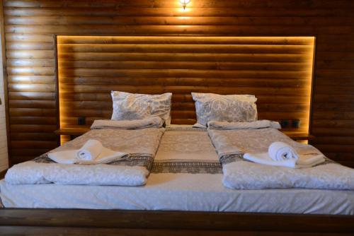 a bedroom with two beds with towels on them at Family Hotel Gotse Delchev in Gotse Delchev