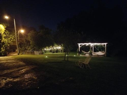a park at night with a tent and a bench at Hacienda Patria 