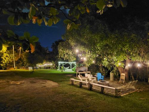 a park with chairs and a playground at night at Hacienda Patria 