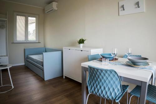 a kitchen and dining room with a table and chairs at Balconi Del Conero in Numana