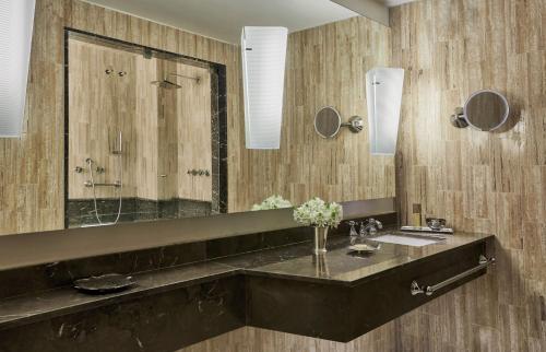 a bathroom with a sink and a large mirror at Four Seasons Hotel Casa Medina Bogota in Bogotá