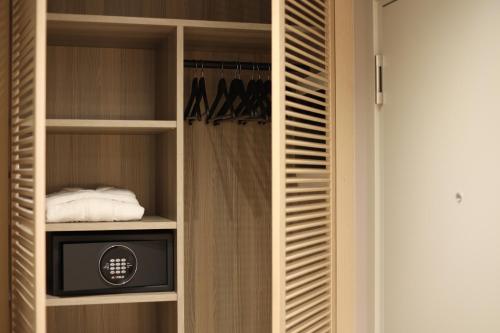 a walk in closet with a television in it at ALYACHT Premium Hotel in Sarandë