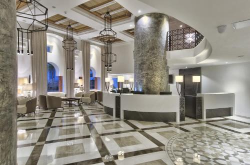 a lobby of a hotel with a reception desk at db San Antonio Hotel + Spa All Inclusive in St. Paul's Bay