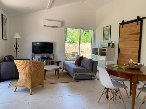 a living room with a couch and a table at La Petite Caserne - Gite 4 étoiles - in Pont-de-Labeaume