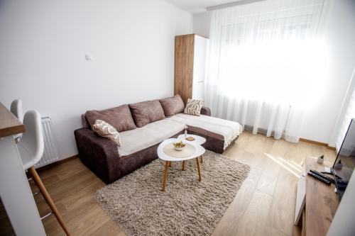 a living room with a couch and a table at Apartman Minja in Subotica