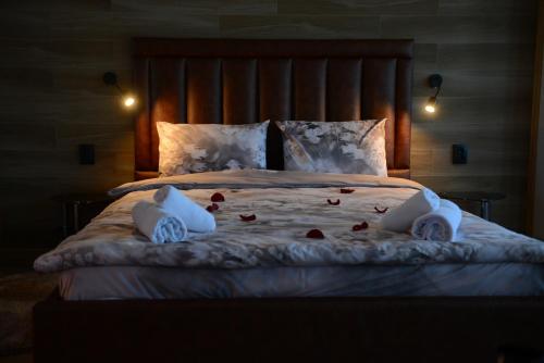 a bedroom with a large bed with roses on it at Family Hotel Gotse Delchev in Gotse Delchev
