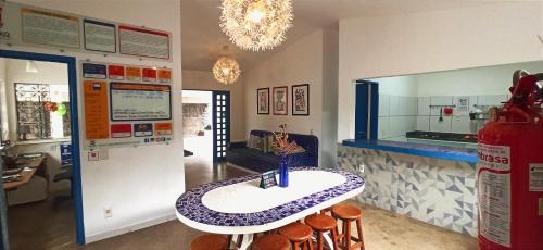 a kitchen with a table and a counter top at Hostel Republika in Natal