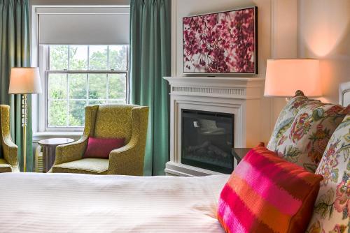 a hotel room with a bed and a fireplace at Queens Landing in Niagara on the Lake