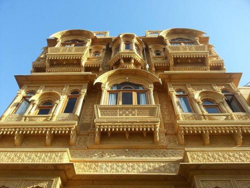 a tall building with windows and balconies on it at Hotel Amazing Jaisalmer in Jaisalmer