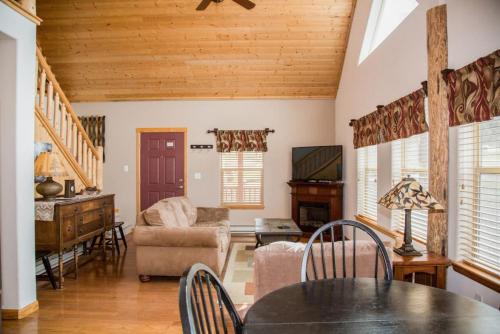 a living room with a table and a couch at Twin Owls Lodge, Great for families Master bedroom, Loft, full kitchen, Dogs OK in Estes Park