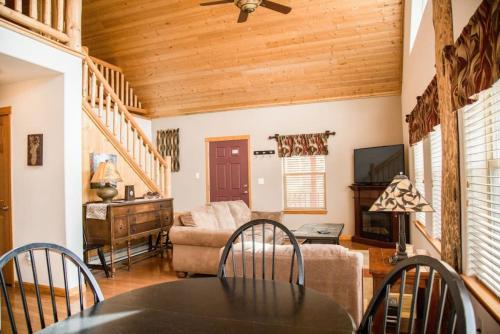 a living room with a table and a couch at Twin Owls Lodge, Great for families Master bedroom, Loft, full kitchen, Dogs OK in Estes Park