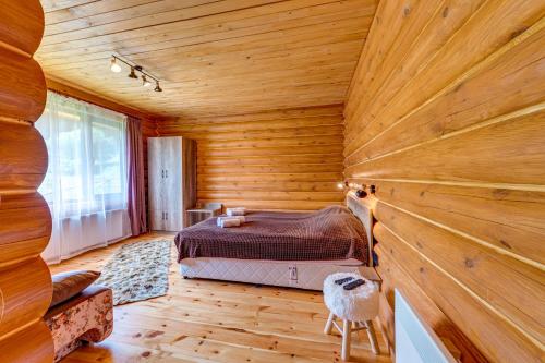 a bedroom with a bed in a wooden room at Вила Морава in Pamporovo