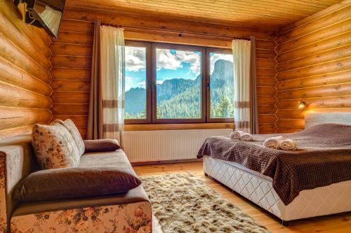 a bedroom with a bed and a chair and a window at Вила Морава in Pamporovo