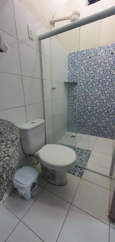 a bathroom with a toilet and a shower at Pousada Azevedo in Livramento de Nossa Senhora