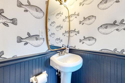 a bathroom with a sink and a mirror at Sand Shack in Frisco