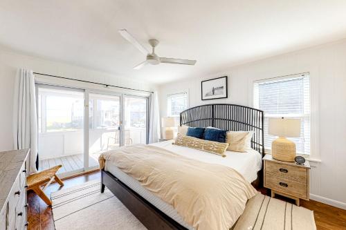 a bedroom with a bed with a ceiling fan at Sand Shack in Frisco