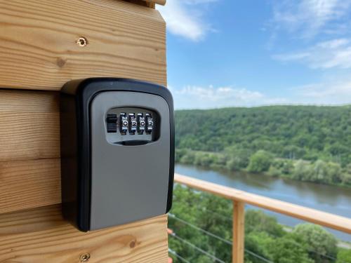 a house with a remote control on the side of a balcony at Chatka - B - Vyhlídka nad řekou in Zdiby