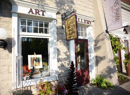 an art store with a sign in front of a window at Jordan House Hotel in Jordan