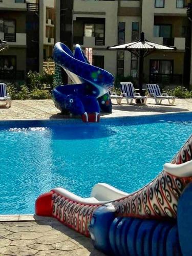 a swimming pool with a water slide in a building at Chalet in Bluebay Asia Resort Ain Sokhna in Ain Sokhna