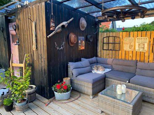 a cat sleeping on a couch on a patio at Piccobello Bed & Breakfast Valløby Køge in Valløby
