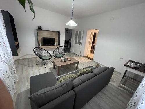 a living room with a couch and a table at BELA VILA in Negotin