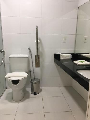 a bathroom with a toilet and a sink at Hotel Palace Santarém Brasil in Santarém